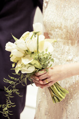 The bride holds a bouquet