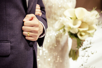 A close-up image of wedding ring of groom in wedding venue