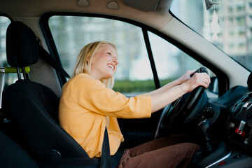 Fototapeta na wymiar Beautiful woman driving a car. Happy woman going on the trip.