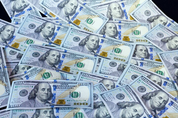 Dollars laid out on a black background.