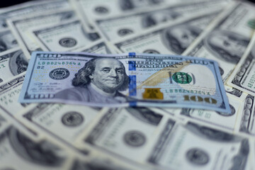 Dollars laid out on a black background.