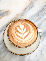 top view cup of cappuccino coffee with latte art on marble table