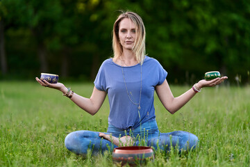 Young woman yoga practitioner in the forest