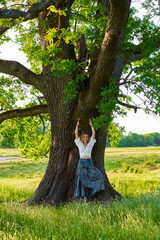 Young woman yoga practitioner in the forest