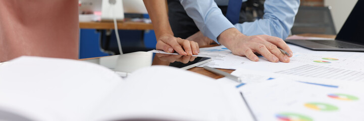 Business man and woman studying documents at table in office closeup
