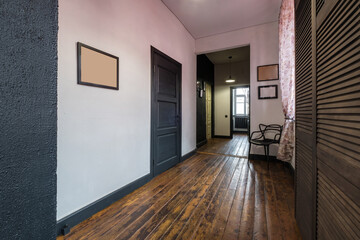 long corridor in interior of entrance hall of vintage apartments with doors in loft interior with brick walls