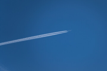 Big commercial airplane leaving contrails in the sky