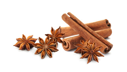 Aromatic cinnamon sticks and anise stars with seeds on white background