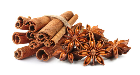 Aromatic cinnamon sticks and anise stars with seeds on white background