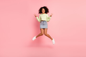Fototapeta na wymiar Full size photo of young cheerful girl jump up show fingers peace v-symbol isolated over pink color background