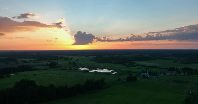 Birds fly past the drone. Beautiful sunset. Slow motion footage. Aerial footage of scenic sunset in small town.