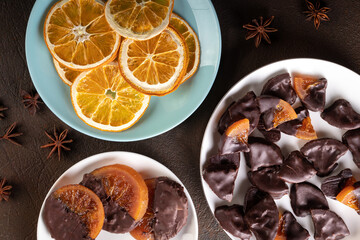 Candied oranges with chocolate. Dryed oranges and cinnamon. Top view.