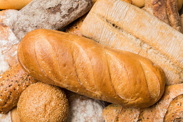 Homemade natural breads. Different kinds of fresh bread as background, top view with copy space