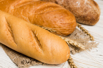 Homemade natural breads. Different kinds of fresh bread as background, perspective view with copy space
