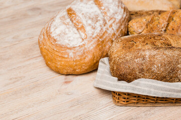 Homemade natural breads. Different kinds of fresh bread as background, perspective view with copy space