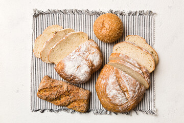 Freshly baked bread slices on napkin against natural background. top view Sliced bread