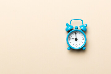 Alarm clock isolated on colored background with copy space top view