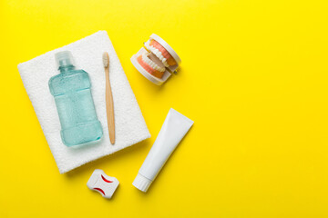 Mouthwash and other oral hygiene products on colored table top view with copy space. Flat lay. Dental hygiene. Oral care kit. Dentist concept