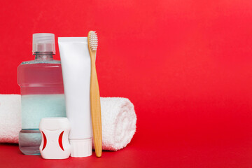 Mouthwash and other oral hygiene products on colored table top view with copy space. Flat lay. Dental hygiene. Oral care products and space for text on light background. concept - obrazy, fototapety, plakaty