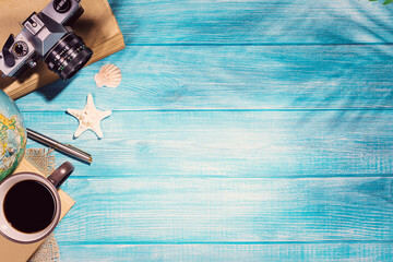 Fototapeta na wymiar Top view of summer beach accessories on marine blue planks pier. Background with copy space and visible wood texture.