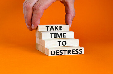 Take time to destress symbol. Concept words Take time to destress on wooden blocks. Beautiful orange table orange background. Psychological business and take time to destress concept. Copy space.