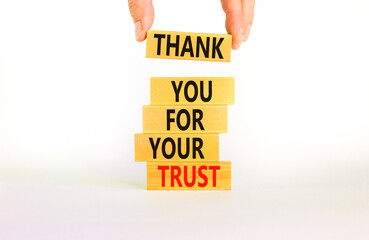 Thank you for trust symbol. Concept words Thank you for your trust on wooden blocks on a beautiful white table white background. Businessman hand. Business and thank you for trust concept.