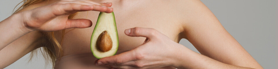 Half-naked white ginger woman posing with avocado