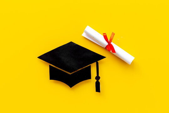 Black mortarboard graduation cap paper cut with diploma. Education concept