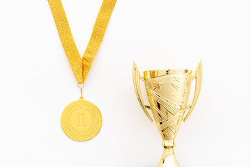 Winner concept with gold medal first place and award trophy cup