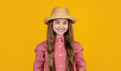 happy teen child in straw hat on yellow background