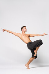 modern ballet male dancer posing over white studio background