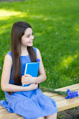 positive child relax with book on park bench