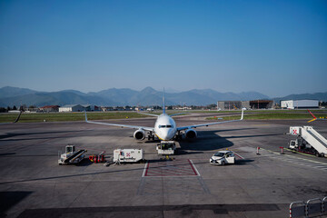 Image of a plane in the airport on a sunny day