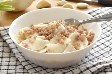 Radish and minced pork stir fried in a white bowl. 