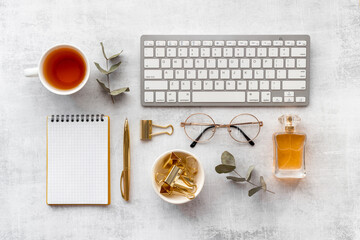 Layout of blogger or designer desktop with computer and golden colored office supplies