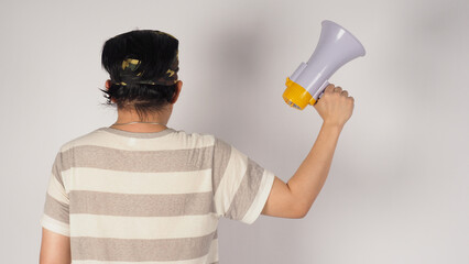 Asian male's  turn around and hand is hold megaphone on white background.