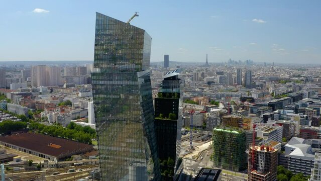 Panoramic aerial view, the Eiffel Tower & buildings & skyscrapers in Paris. Aerial drone shot of the modern La Defense business district in Paris. Aerial drone shot of the Cityscape of Paris, France