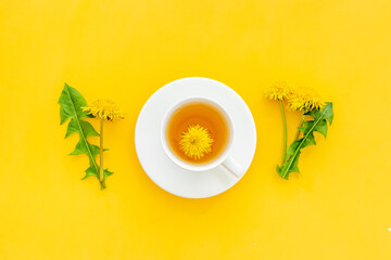Herbal tea with meadow yellow dandelions blossoms and leaves