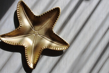 a plate in the shape of a golden star has a place for an inscription