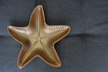 a plate in the shape of a golden star has a place for an inscription