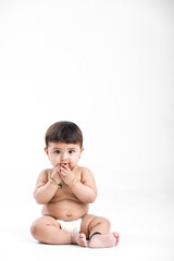 Indian baby girl playing on white background.