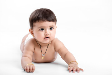 Indian baby girl playing on white background.