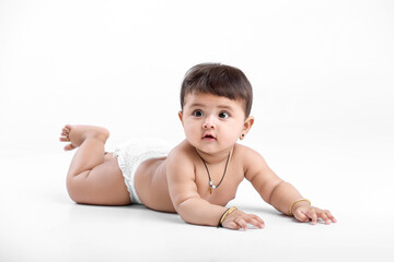 Indian baby girl playing on white background.