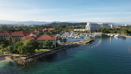 Fototapeta na wymiar Kota Kinabalu, Sabah Malaysia – June 15, 2022: The Tanjung Aru Beach, Fisherman Village and Shangri-La Hotel