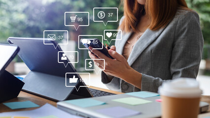 Social media and Marketing virtual icons screen concept.close up of businesswoman typing keyboard with laptop