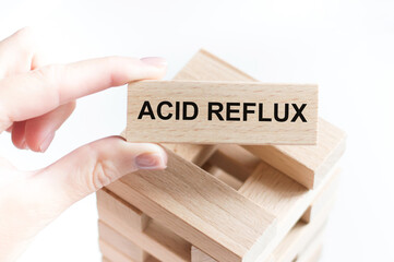 Wooden block form the word ACID REFLUX. Medical concept.