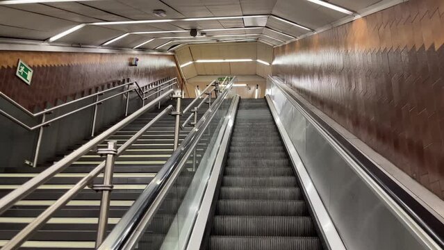 Point of view of person going down on subway scalator and looking up. Reverse, inverse direction, dizziness concepts