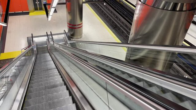 View of empty subway station on moving scalator in metro Madrid. Late hours on public transportation concept