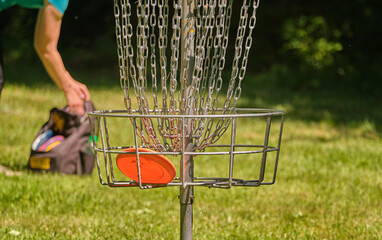 Successful shot in the disc golf basket