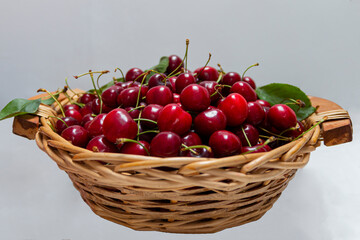 Fresh sweet cherries  in woden basket. Eco production organic fruits - concept. Close up